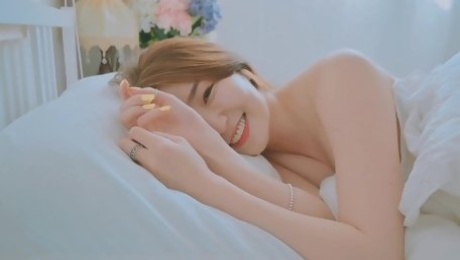 Good morning with young and beautiful Korean woman basking in bed